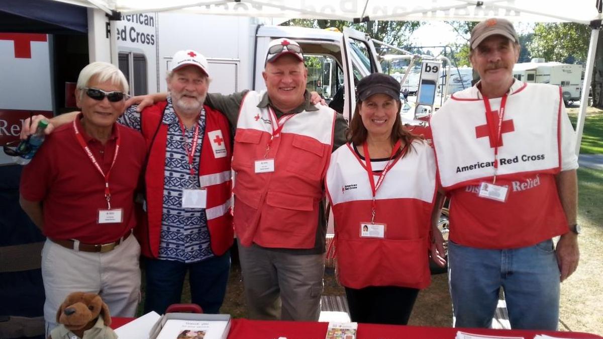 Volunteers Carl Nishioka, left, Don Binder, Ron Conlin, Cynthia Newport and Terry Brennan at the National Night Out booth on Whidbey Island in 2015.