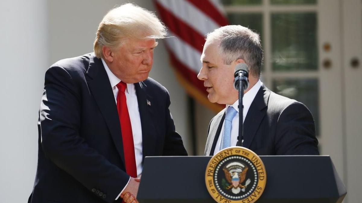 President Donald Trump shakes hands with EPA Administrator Scott Pruitt after speaking about the U.S. role in the Paris climate change accord June 1, 2017, in the Rose Garden of the White House in Washington.