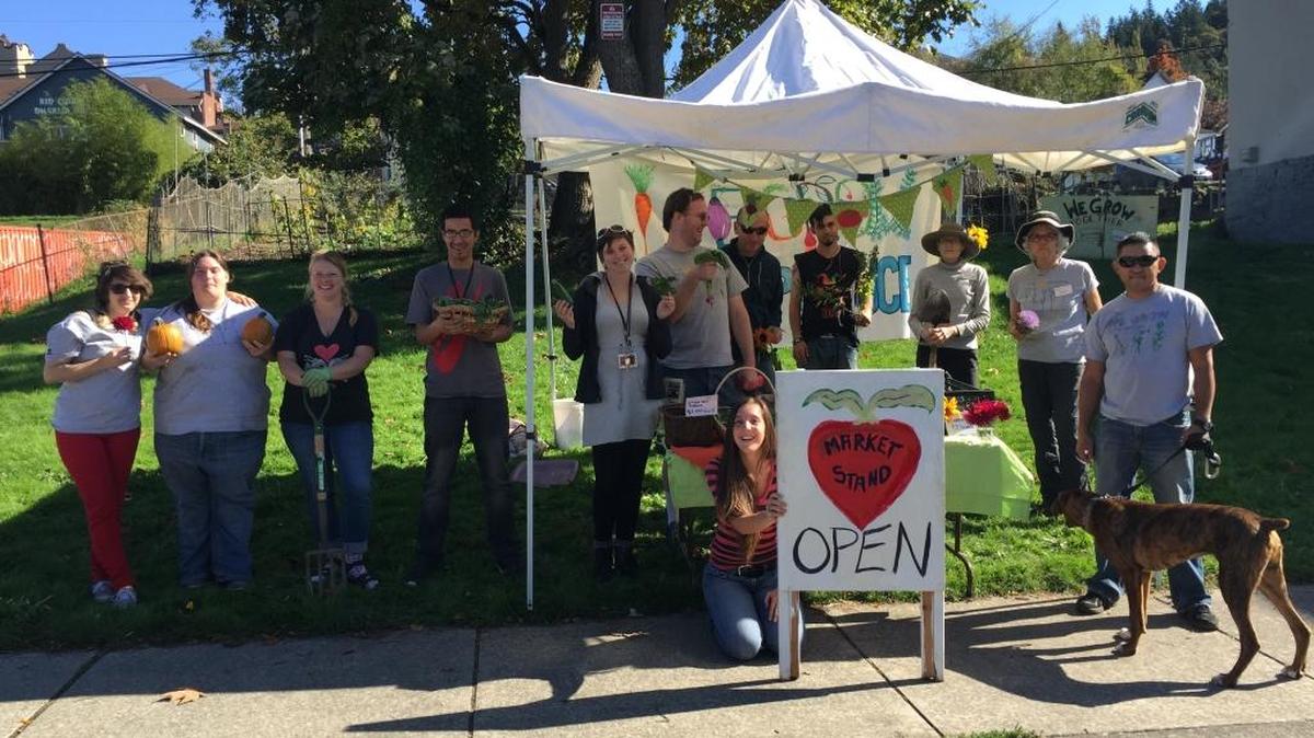 Youth, volunteers, and staff work together to sell fruit, vegetables and flowers grown in the WeGrow Garden, part of Northwest Youth Services’ Vocational Readiness program in June 2014, in Bellingham.