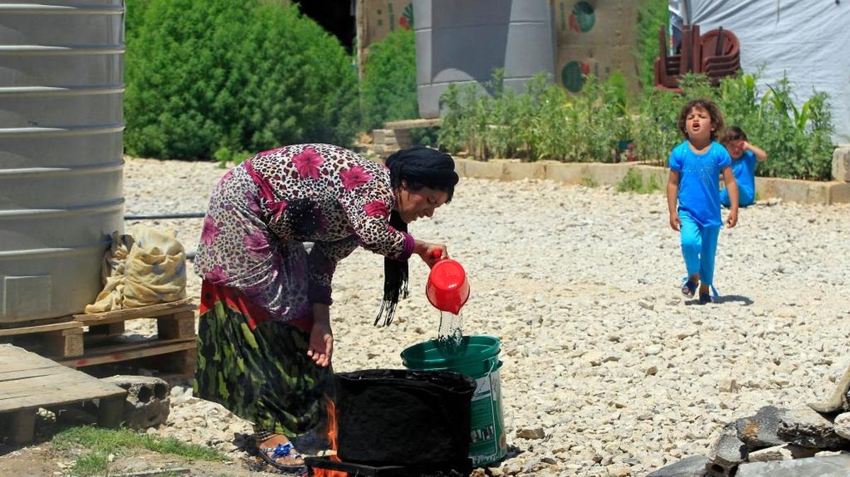 A Syrian refugee cooks food for her family outside her tent at a Syrian refugee camp in the eastern Lebanese town of Saadnayel, Bekaa Valley, Lebanon, Lebanon, Tuesday, July 19, 2016. Human Rights Watch, a leading international human rights group, said in a report released Tuesday, that more than half of the nearly 500,000 school-age Syrian children registered in Lebanon do not go to school and receive no formal education. Since Syria's conflict began in March 2011, hundreds of thousands of Syrians have fled to Lebanon, which is now home to some 1.1 million registered refugees.