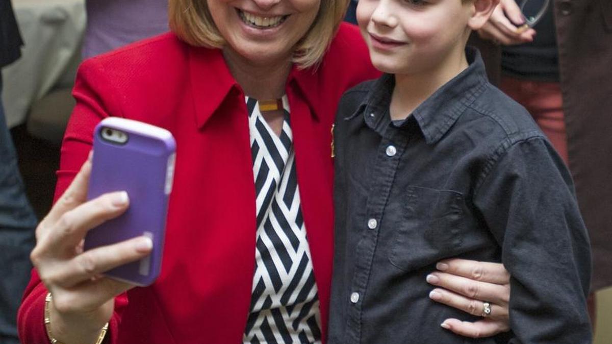 Luanne Van Werven captures a photo with her grandson Clayton Van Werven after finding out she won the 42nd House on Monday, Nov. 4, 2014 at the Bellingham Country Club.