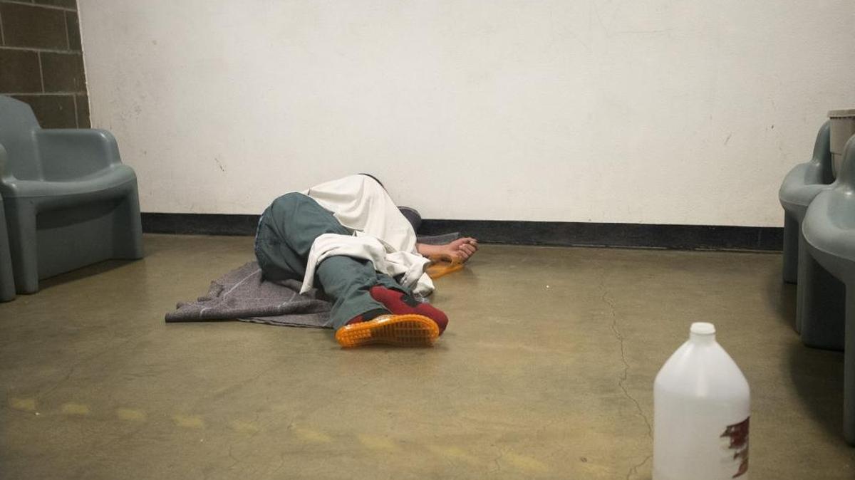 An intoxicated inmate naps on the floor of a temporary holding cell shortly after being booked in but before being moved to more permanent housing in July, 2015, at Whatcom County Jail in Bellingham. Cells designated for inmates with drug or behavior issues often fill quickly on nights and weekends giving jail staff few options on where to house them. (The date of this image was corrected April 6, 2016.)