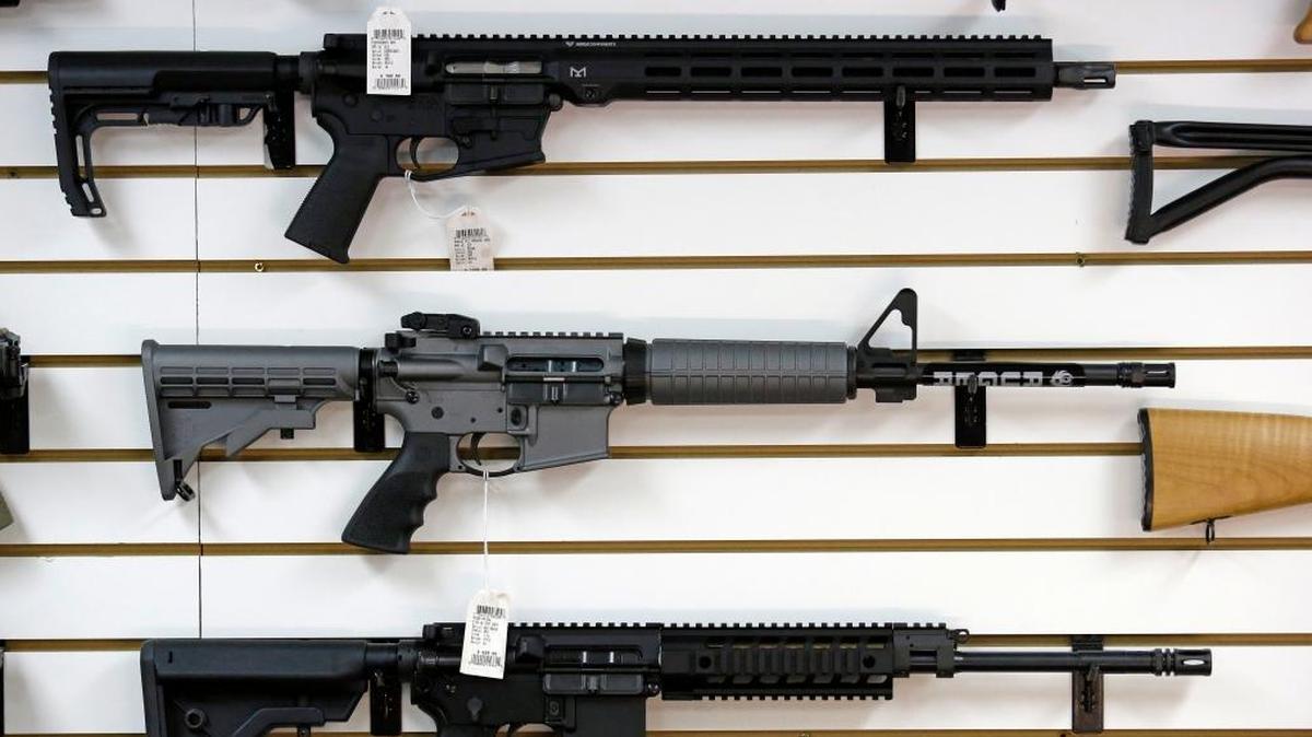 A Ruger AR-15 semi-automatic rifle, center, sits on display with other rifles on a wall in a gun shop Nov. 7 in Lynnwood, Wash.