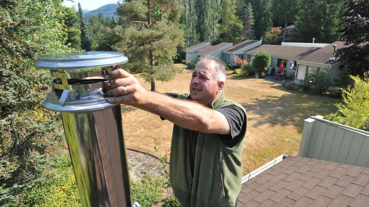 Howard Lopeman of The Chimney Sweep installs a chimney in 2012 in Sudden Valley for a new freestanding wood stove that exceeds EPA emissions requirements.