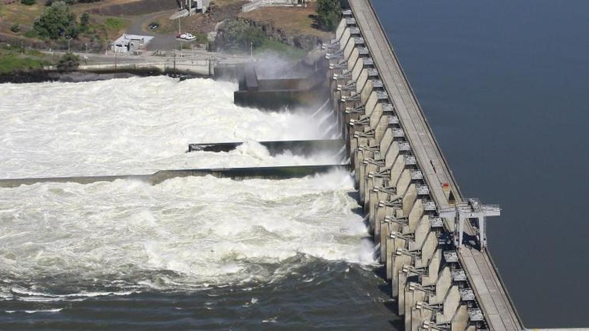 In this file photo, water flows through the Dalles Dam, along the Columbia River, in The Dalles, Ore. Negotiations with Canada to re-authorize the landmark Columbia River Treaty are set to begin early in 2018. The updating of the treaty affects the economy, environment, and flood control needs of millions of residents of the four states along more than 1,200 miles of the Columbia River and its tributaries.