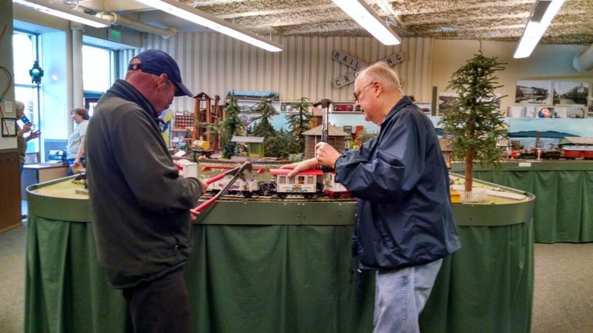 Volunteers Randy German and Michael Lower demonstrate their expertise in train maintenance and their sense of humor at the Bellingham Railway Museum.