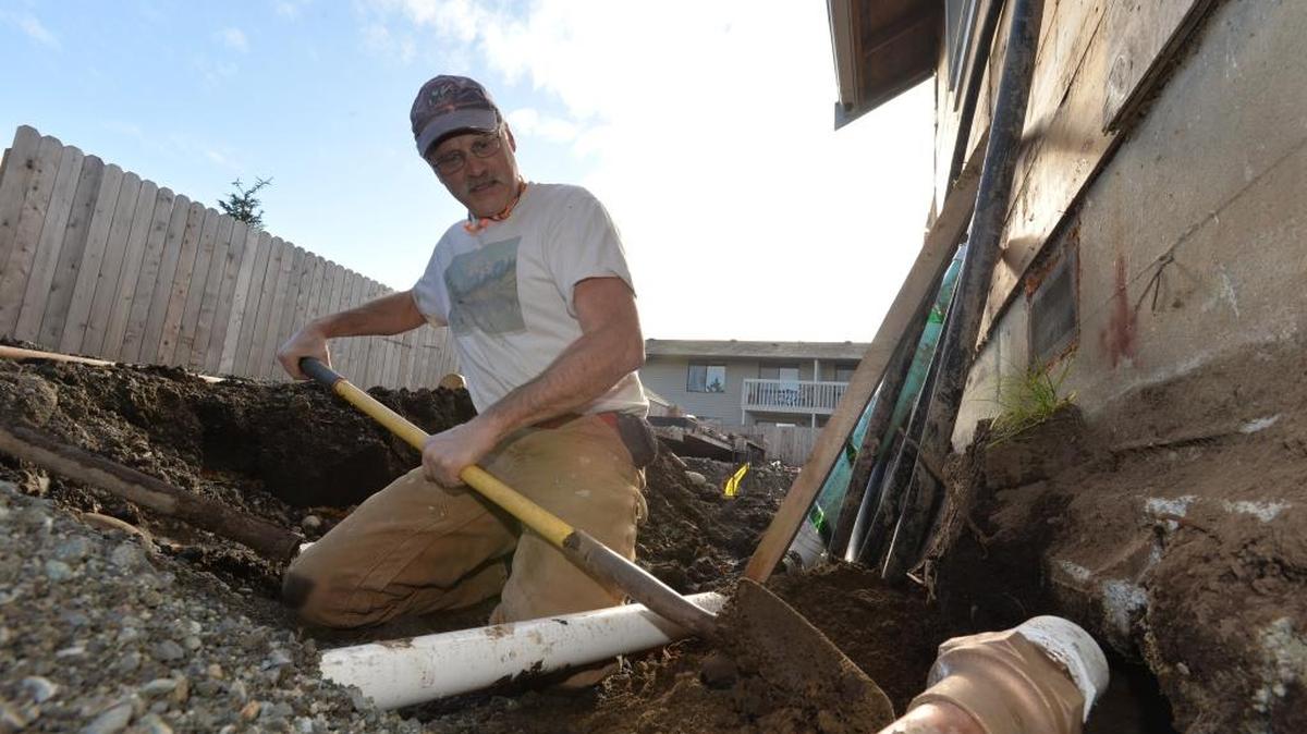 Interfaith Coalition of Whatcom County project manager Mike Hess digs under the foundation of a Ferndale house being converted into a triplex for homeless families in 2013. The Interfaith Coalition is now partnering with Family Promise to works with congregations to provide space in their buildings to serve as temporary shelters for families.