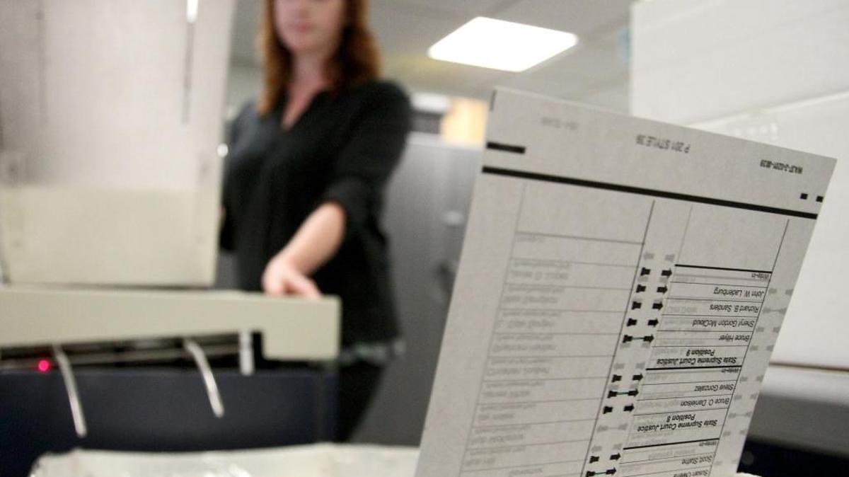 Kimberly Boulanger watches ballots fly out of a ballot counting machine in 2012 at the Whatcom County Courthouse in Bellingham. The machine reads 400 ballots a minute. Each voter’s identification is kept confidential and each ballot is hand inspected before being run through the ballot counting machine. A few stacks of ballots are hand counted after being run through the machine to verify accuracy.