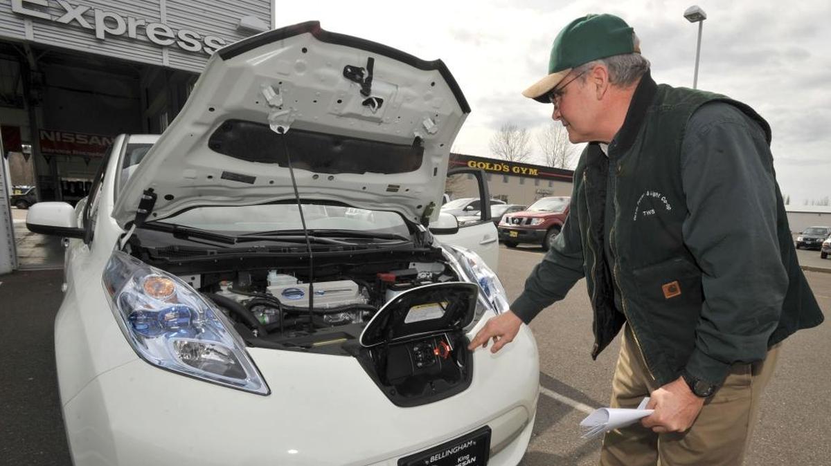 Todd Shaner of Orcas Power & Light Cooperative checks out the front plug-in for the all-electric Nissan Leaf King Nissan in Bellingham in 2011. The cooperative bought the first Leaf sold in Whatcom County.