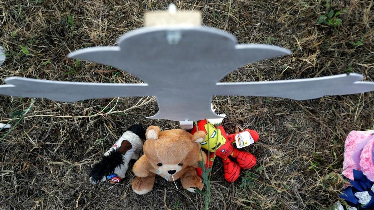 Stuffed animals sit at the base of a cross at a makeshift memorial for victims near the scene of a shooting at the First Baptist Church of Sutherland Springs, Nov. 7, 2017, in Sutherland Springs, Texas. A man opened fire inside the church in the small South Texas community on Sunday, killing more than two dozen and injuring others.