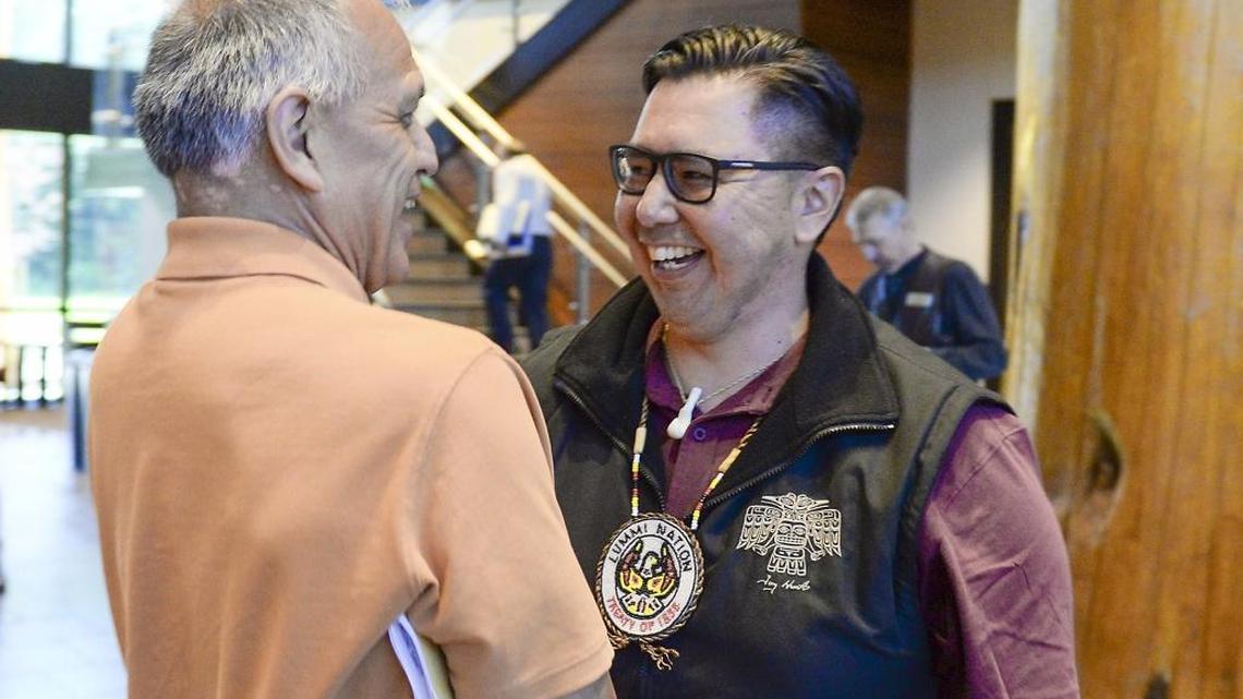 Former Lummi Indian Business Council Chairman Darrell Hillaire, left, shakes hands with Lummi Chairman Tim Ballew II after Ballew announced in Lummi Council chambers Monday, May 9, 2016 that the U.S. Army Corps of Engineers denied a needed permit for a proposed coal terminal at Cherry Point.