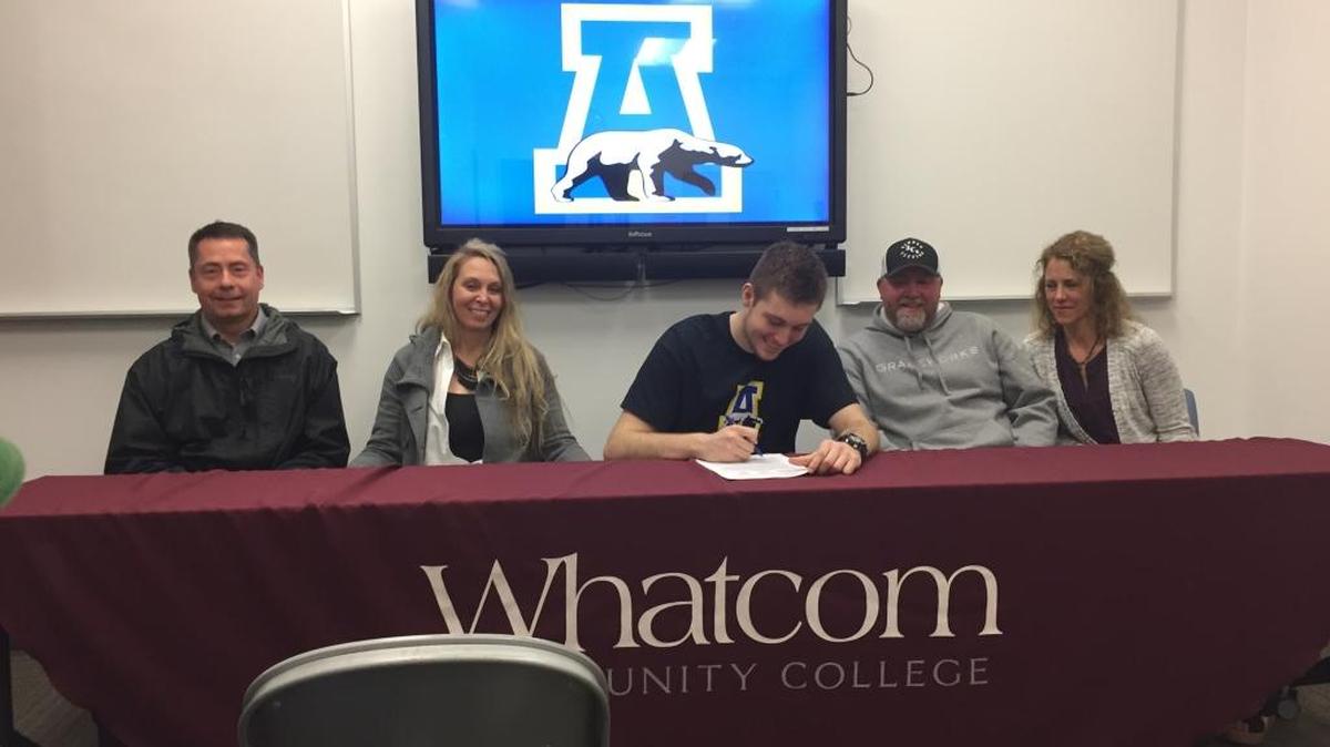 Former Whatcom Community College and Lynden Christian basketball player signs to play for the University of Alaska at a ceremony Monday at WCC.