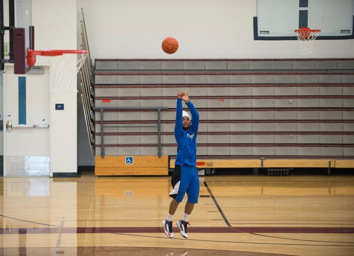 Jaskeert Singh shoots baskets while waiting for a friend in the new Whatcom Community College Pavilion and Student Recreation Center.