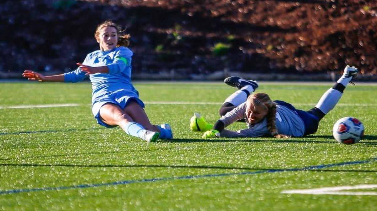 Western Washington’s Catherine Miles works the ball around Dallas Baptist goalie Jenna Ackerly during the NCAA Division II national quarterfinals on Saturday, Nov. 21, at Harrington Field in Bellingham. Miles scored twice in the Vikings’ 3-1 victory.