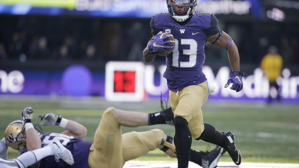 Washington's Chico McClatcher scores against Washington State in the first half of an NCAA college football game Friday, Nov. 27, 2015, in Seattle.
