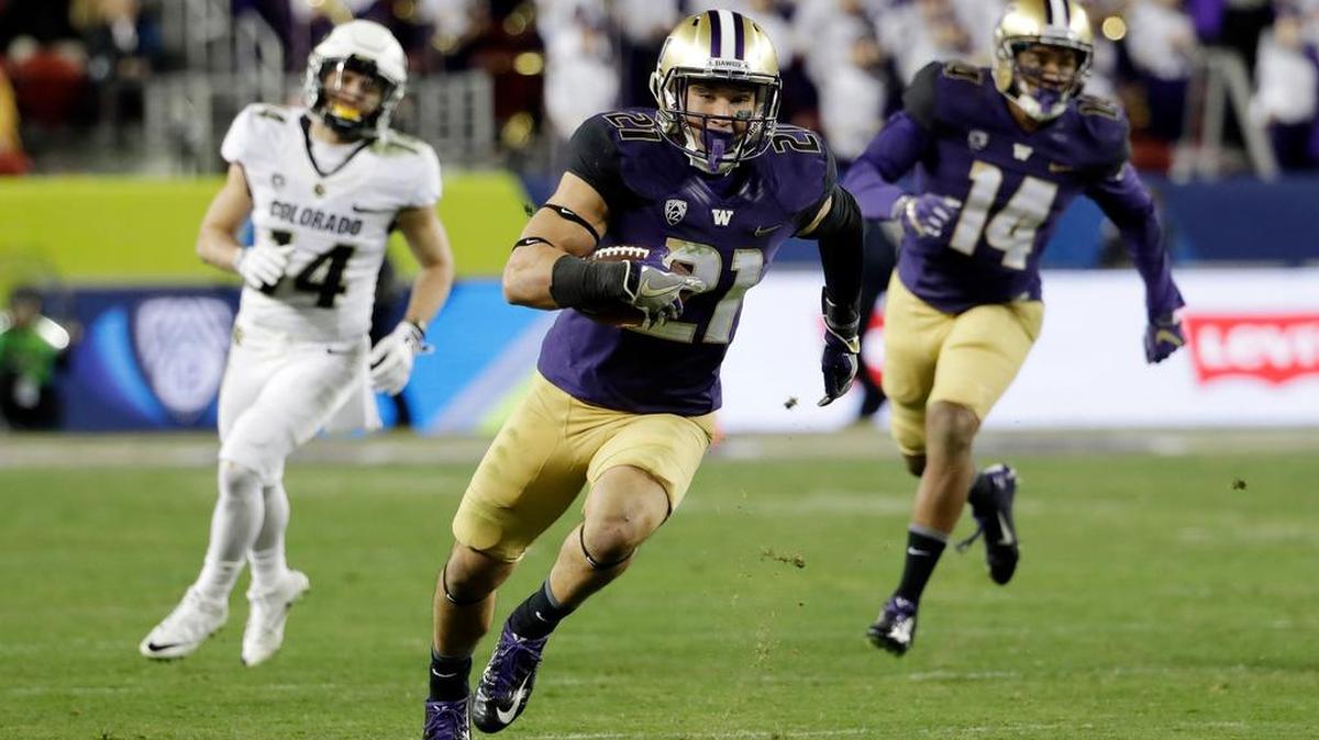 Washington defensive back Taylor Rapp (21), a freshman from Sehome High School, runs after intercepting a Colorado pass in the second half of the Pac-12 championship game.
