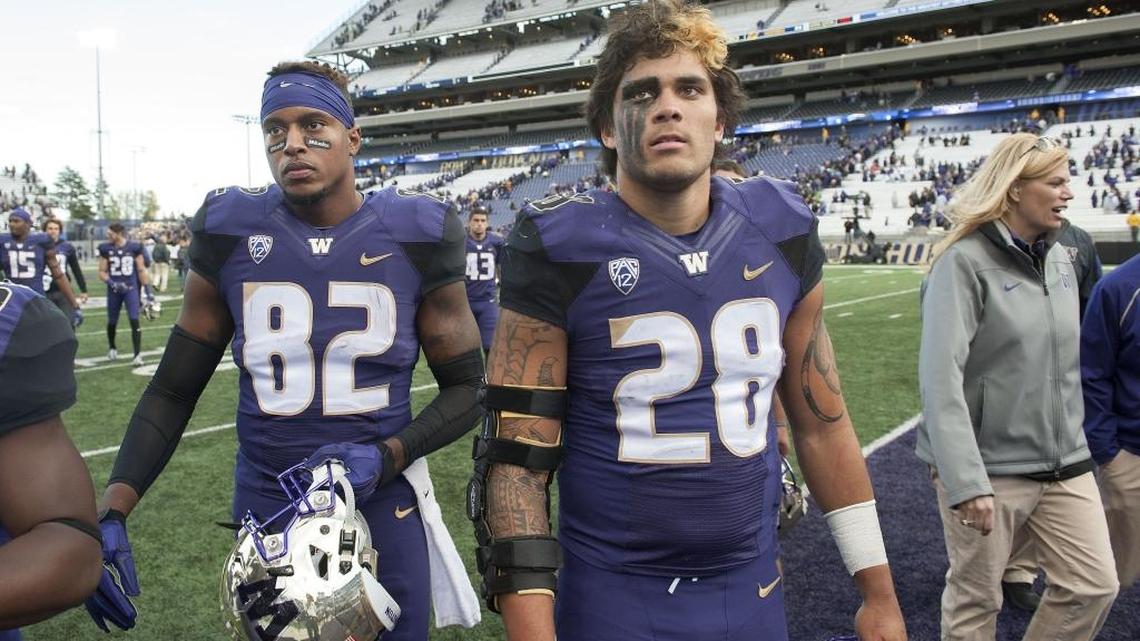 UW tight end Joshua Perkins, left, and receiver Nik Little wear the sting of a close loss to Cal, 30-24, on their faces after the game. Photo taken in Seattle on Saturday, Sept. 26, 2015.