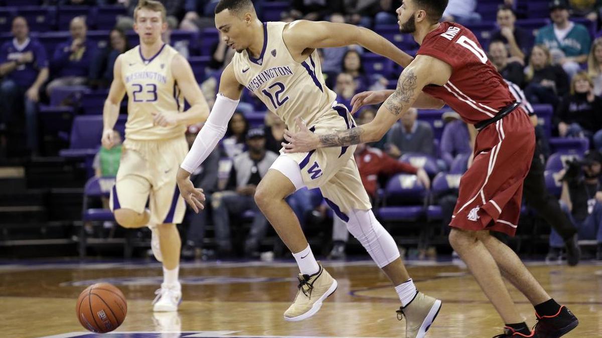 Washington’s Andrew Andrews (12) is fouled by Washington State’s Derrien King late in the second half Wednesday, March 2, in Seattle.