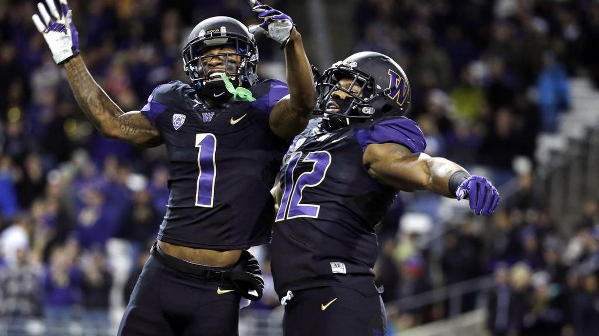Washington's Dwayne Washington (12) celebrates with Jaydon Mickens (1) after Washington’s 13-yard touchdown reception against Arizona in the first half an NCAA college football game Saturday, Oct. 31, 2015, in Seattle.