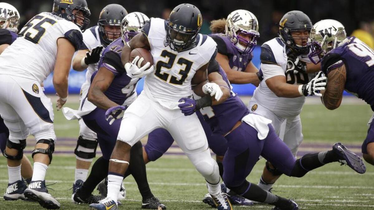 
Washington’s defense attempts to take down Bears running back Vic Enwere in UW’s 30-24 loss to Cal on Saturday. 
