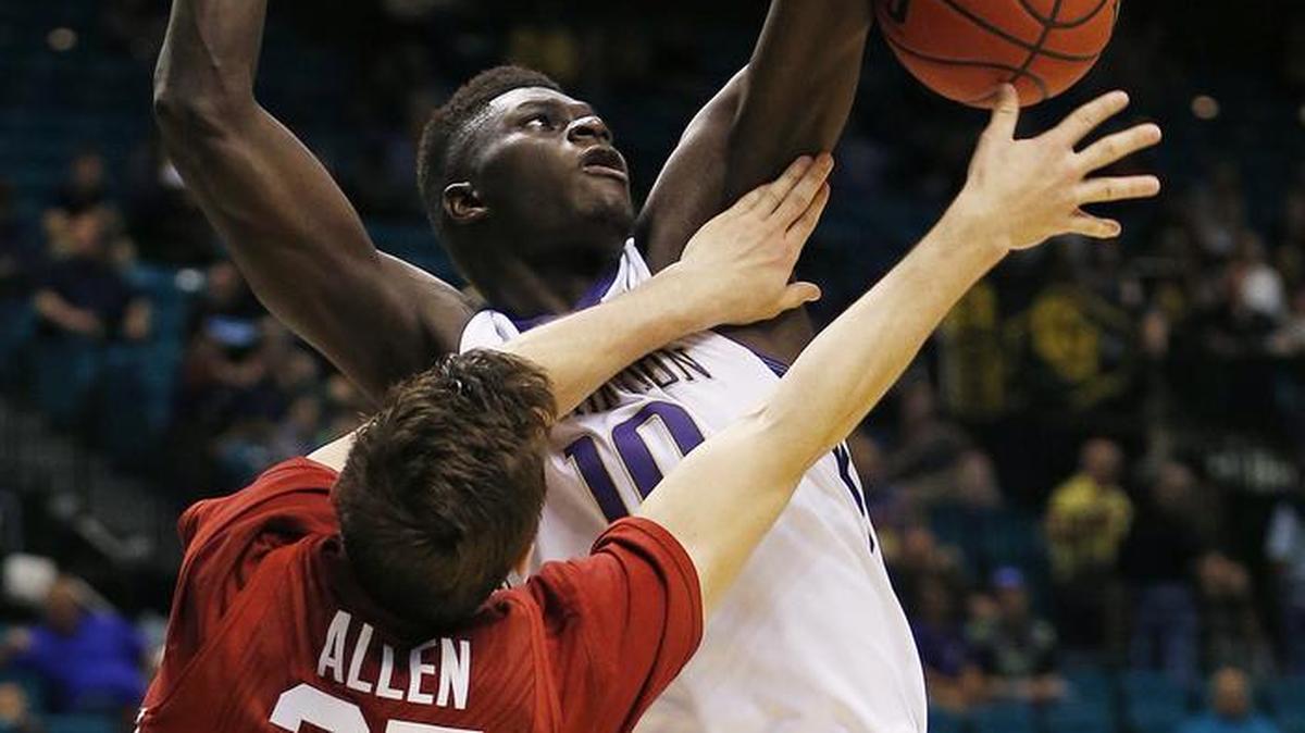 Washington forward Malik Dime (10) blocks a shot by Stanford forward Rosco Allen (25) during the second half of an NCAA college basketball game in the first round of the Pac-12 tournament Wednesday in Las Vegas. Washington won 91-68.