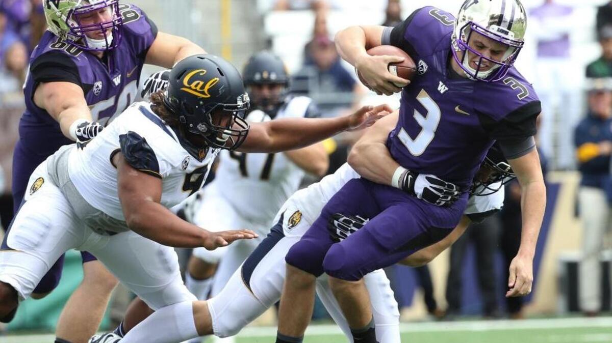 
Washington quarterback Jake Browning (3) gets tackled by California’s Kyle Kragen for one of the Golden Bears’ five sacks Saturday.

