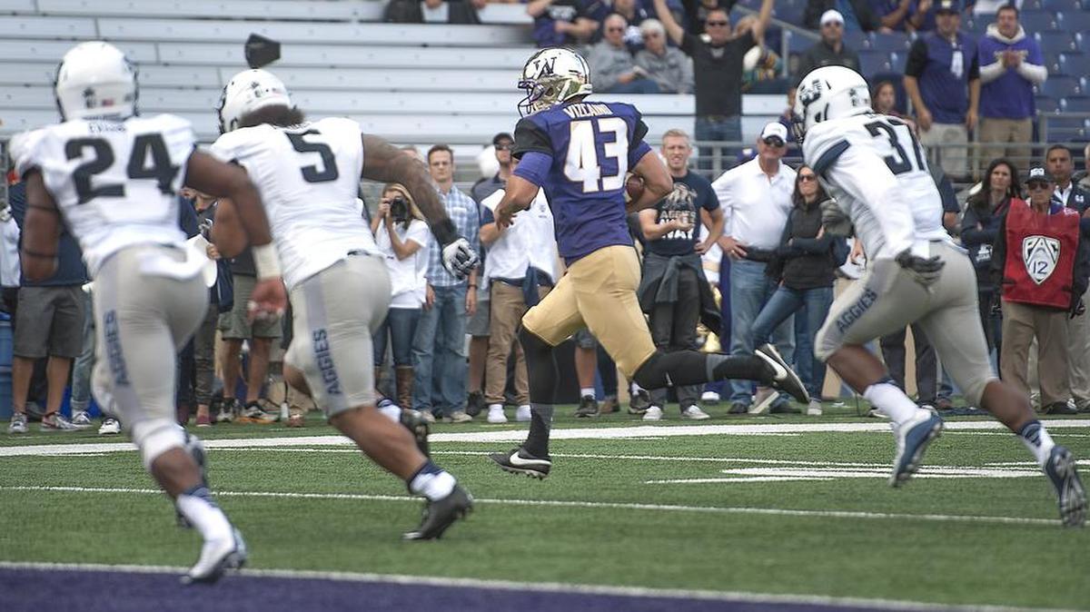 
Huskies kicker Tristan Vizcaino scampers in for a touchdown on a fake field goal attempt Saturday at Husky Stadium. It was the first fake field goal touchdown by a place kicker since at least 1974.
