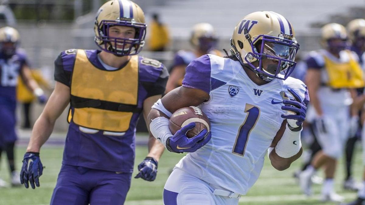 John Ross III (1) returns a punt at the preview on Saturday, April 23. Ross also caught a 9-yard touchdown pass from Jake Browning.