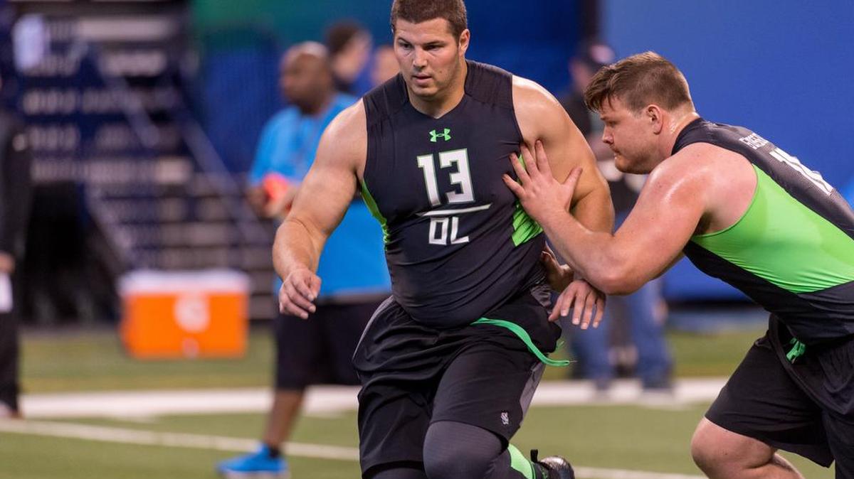 Washington State offensive lineman Joe Dahl, right, runs a drill at the NFL football scouting combine, Friday, Feb. 26, 2016, in Indianapolis.