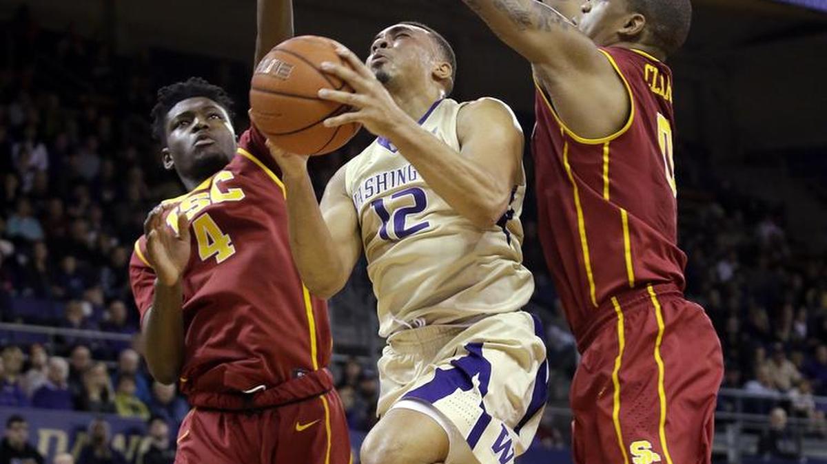 Washington’s Andrew Andrews, center, shoots between a pair of Southern California defenders earlier this month. The Huskies erased a 22-point deficit to win that game against the Trojans. UW plays at UCLA on Thursday and USC on Sunday.