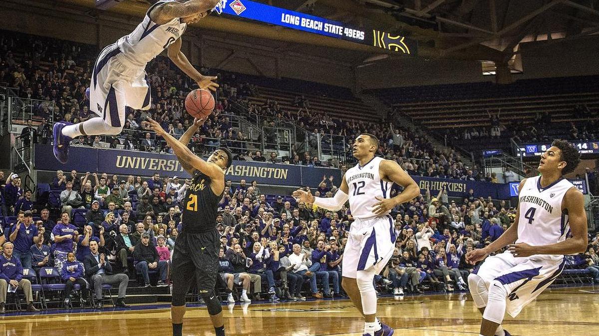 Washington’s Marquese Chriss shows off his hang time on a thunderous dunk over Long Beach State’s Justin Bibbins on Tuesday as fellow Huskies Andrew Andrews (12) and Matisse Thybulle watch Tuesday during a NIT first round game against Long Beach State in Seattle. UW won 107-102.