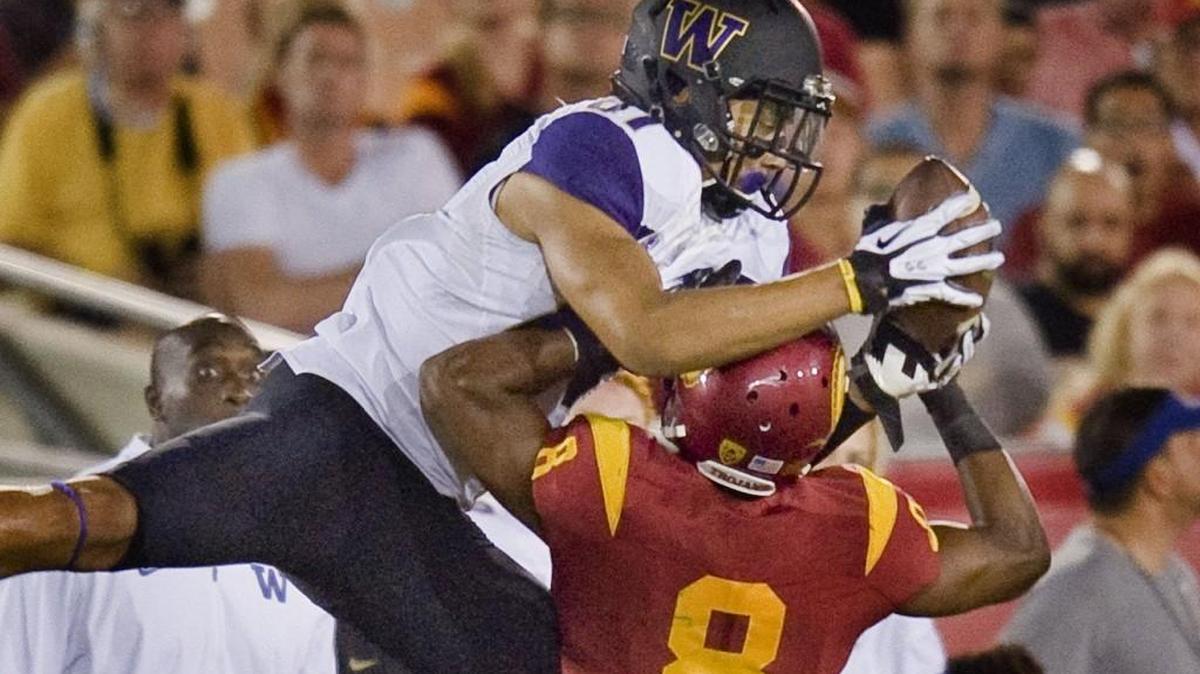 Washington wide receiver Brayden Lenius reaches over Southern California cornerback Iman Marshall to catch a pass during the third quarter of an NCAA college football game Thursday, Oct. 8, 2015, in Los Angeles. Washington won 17-12.