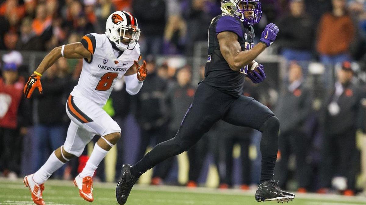 
Washington running back Dwayne Washington finds an open hole in the middle of the field and rushes 68 yards for a touchdown in the first quarter against Oregon State at Husky Stadium in Seattle on Nov. 22, 2014.
