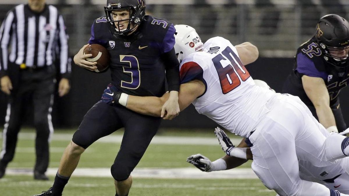 Washington quarterback Jake Browning (3) carries the ball as Arizona defensive lineman Luca Bruno (60) tackles him in the first half an NCAA college football game Saturday, Oct. 31, 2015, in Seattle.