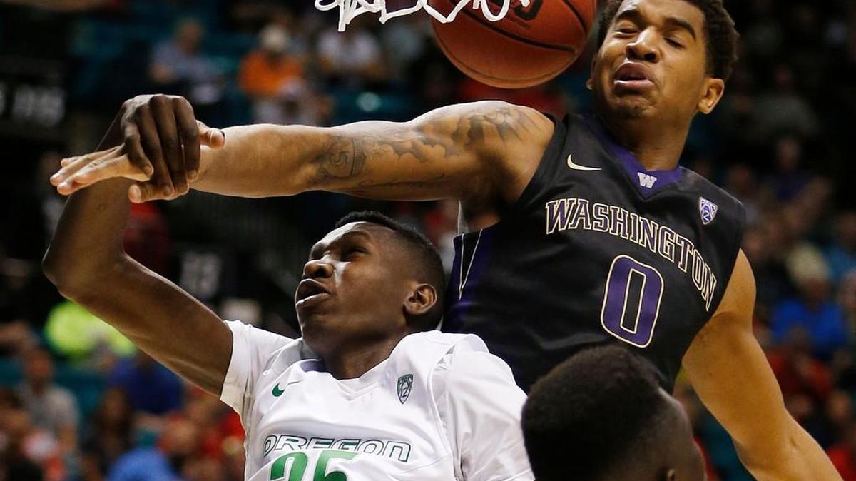Washington forward Marquese Chriss (0) and Oregon forward Chris Boucher (25) battle for a rebound during the second half of an NCAA college basketball game in the quarterfinal round of the Pac-12 men's tournament Thursday, March 10, 2016, in Las Vegas. Oregon won 83-77.