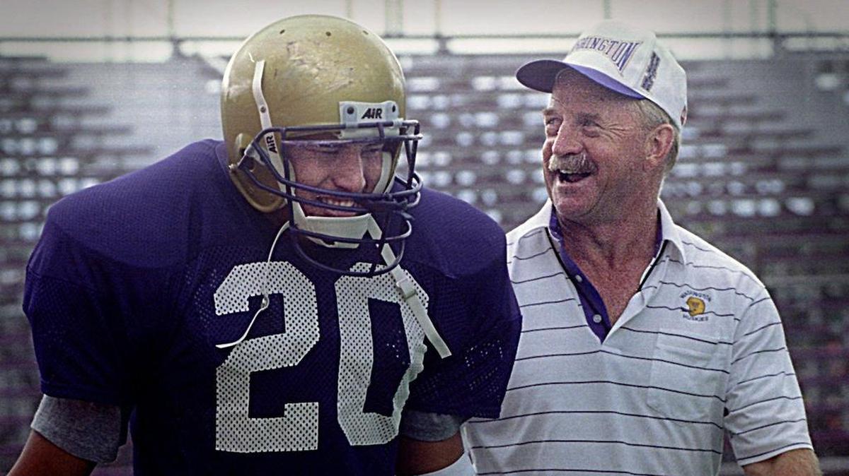 Free safety Ikaika Malloe laughs with Husky coach Jim Lambright during two-a-day practices at Husky Stadium in August 1994.