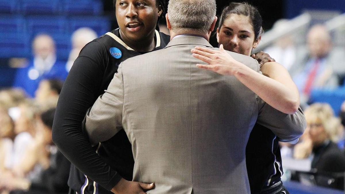 From Left, Washington’s Chantel Osahor, coach Mike Neighbors and Kelsey Plum hug in the closing moments of Sunday’s regional final against Stanford in Lexington, Ky. Washington won, 85-76.