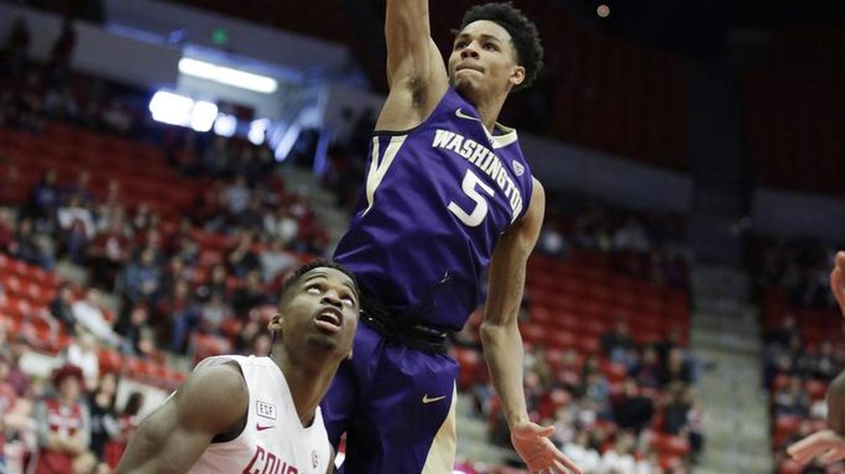 Washington's Dejounte Murray (5) shoots against Washington State's Ike Iroegbu (2) during the first half in Pullman.