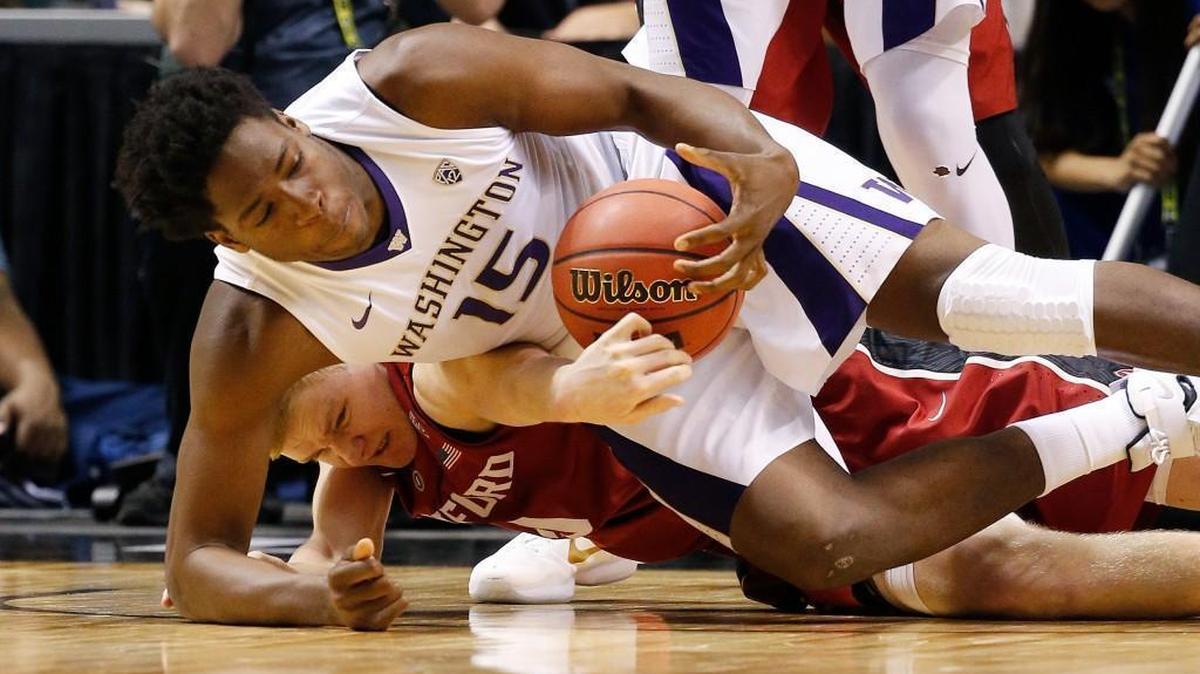 Washington forward Noah Dickerson (15) scrambles for the ball with Stanford forward Michael Humphrey during the first half of an NCAA college basketball game in the first round of the Pac-12 tournament Wednesday in Las Vegas.