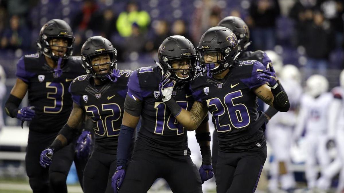 Washington defensive back Sidney Jones (26) is congratulated after an interception against Arizona in the first half Saturday, Oct. 31, in Seattle.