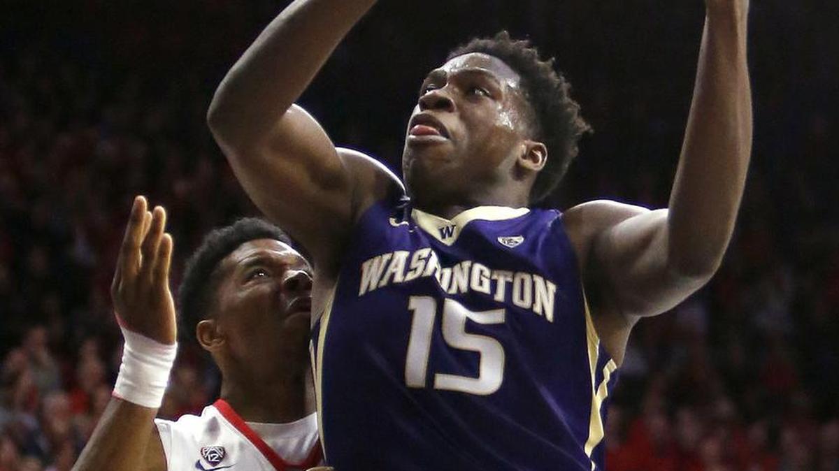 Washington forward Noah Dickerson (15) drives on Arizona guard Justin Simon during the first half of an NCAA college basketball game Thursday, Jan. 14, 2016, in Tucson, Ariz.