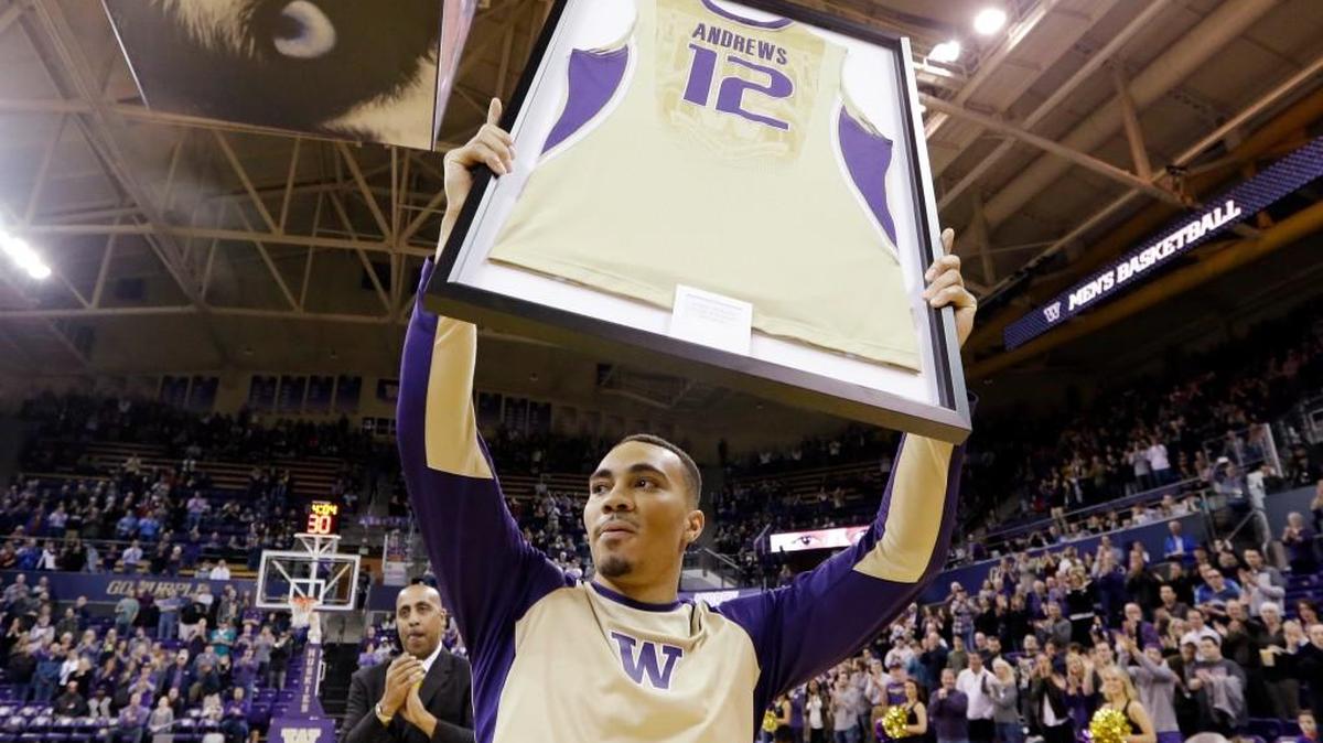 Washington's Andrew Andrews holds up a replica of his jersey as he is honored during senior night before an NCAA college basketball game against Washington State Wednesday, March 2, 2016, in Seattle. (AP Photo/Elaine Thompson)