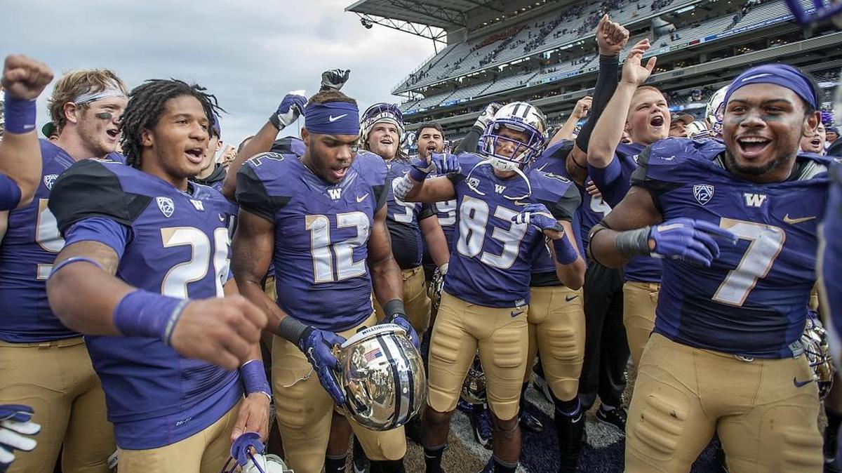 
A triumphant Huskies squad sings “Bow Down to Washington” after beating Utah State, 31-17, at Husky Stadium in Seattle on Saturday, Sept. 19, 2015. From left: defensive back Sidney Jones, tailback Dwayne Washington, wide receiver Neel Salukhe, punter Korey Durkee and linebacker Keishawn Bierria.
