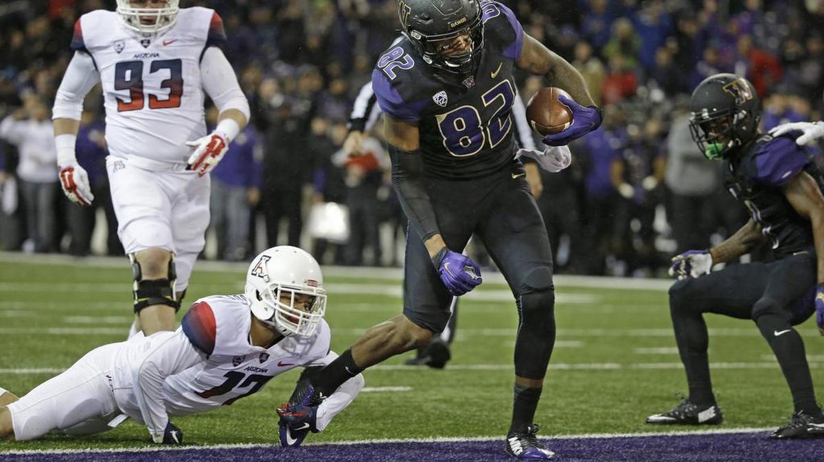 Washington’s Joshua Perkins (82) scores against Arizona last weekend. As for playing Utah on Saturday: “I think we’re going to have to do a good job of making plays on the ball,” he said.