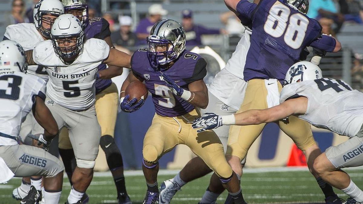 
Washington running back Myles Gaskin, who rushed for 47 yards, looks for running room Saturday against Utah State. 
