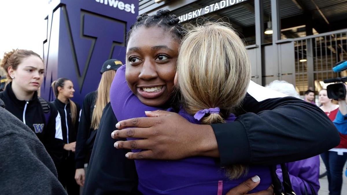 Washington’s Chantel Osahor gets a hug during a departure rally for the Washington women’s basketball team Thursday, March 31, 2016, in Seattle. Washington plays Syracuse in a national semifinal at the Final Four of the NCAA Tournament Sunday in Indianapolis.
