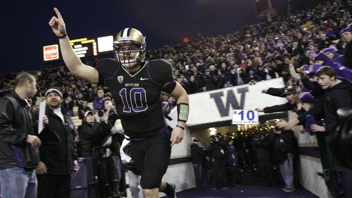 Washington quarterback Jake Locker runs onto the field for his final career home game against UCLA in an NCAA college football game Thursday, Nov. 18, 2010, in Seattle. Washington won 24-7.