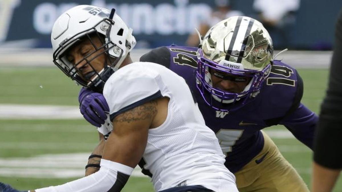 UW’s Sidney Jones, on turf, helps force a Utah State fumble. He forced three fumbles, had four picks in 2015.