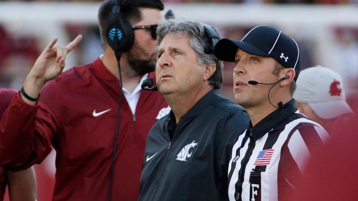 Washington State head coach Mike Leach, center, watches a replay during the first half of an NCAA college football game against the Eastern Washington in Pullman, Wash., Saturday, Sept. 3, 2016.