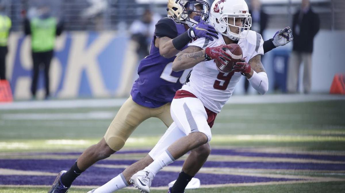 Washington State’s Gabe Marks (9) runs with the ball as Washington’s Sidney Jones defends during the Apple Cup on Friday. Marks and Jones made the All-Pac-12 first team.
